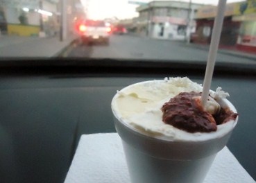 Mexican street corn with a spoon in a styrofoam cup.