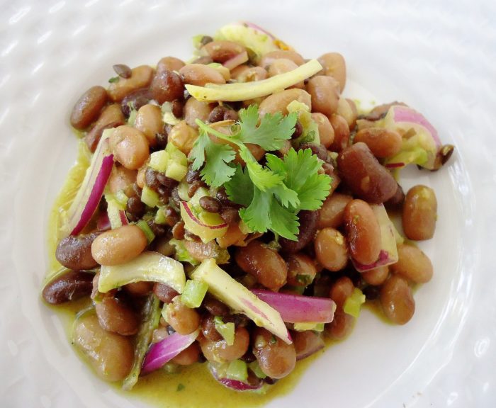 Curried beluga lentil pebble bean salad combines ginger, garlic, lemon cilantro, red onion, curry powder, lentils for a protein packed salad.