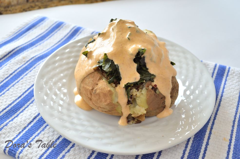 Creamy vegan chipotle sauce poured over a loaded baked potato.