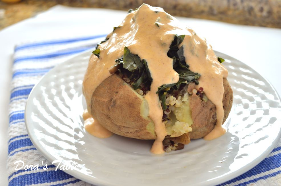 Creamy vegan chipotle sauce poured over a loaded baked potato.