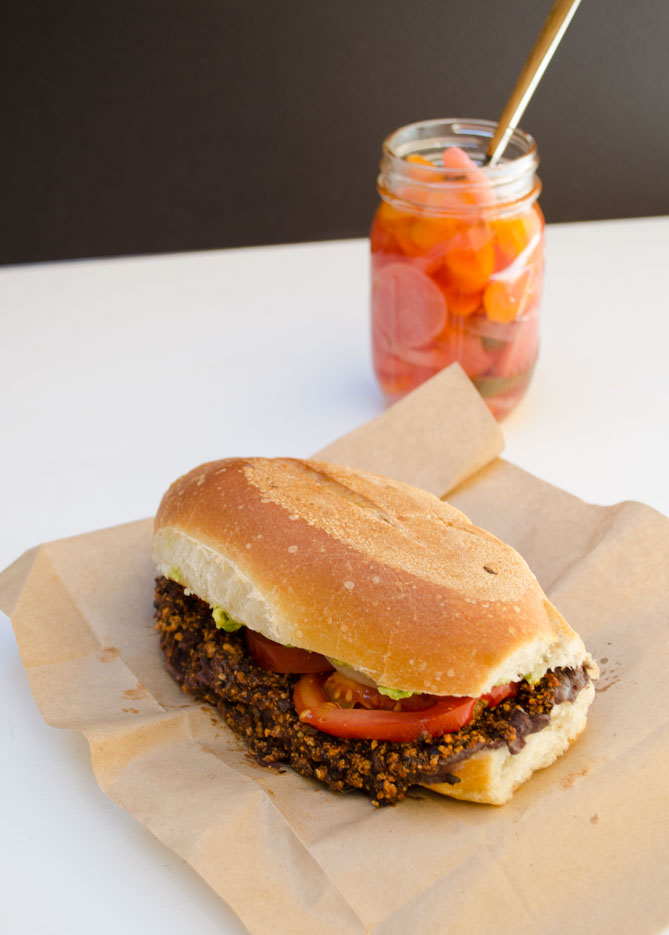 Vegan chorizo torta on a piece of brown paper on a white counter.