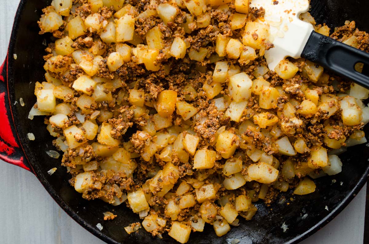 Vegan potato and chorizo taco filling in a cast iron skillet.