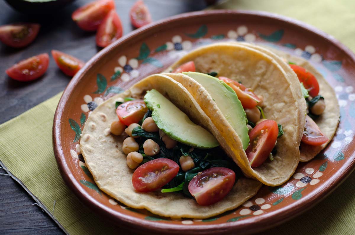 This recipe for chickpea and spinach tacos is my go-to easy lunch. Serve on warm corn tortillas, topped with cherry tomatoes, avocado, salsa, and pepitas.