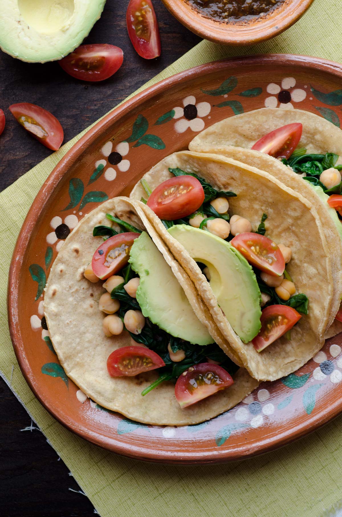 This recipe for chickpea and spinach tacos is my go-to easy lunch. Serve on warm corn tortillas, topped with cherry tomatoes, avocado, salsa, and pepitas.