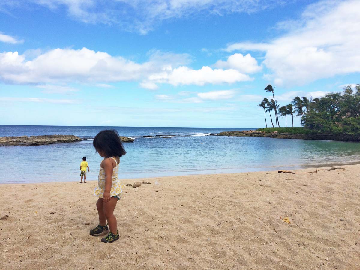 A small girl on the beach in Hawaii.