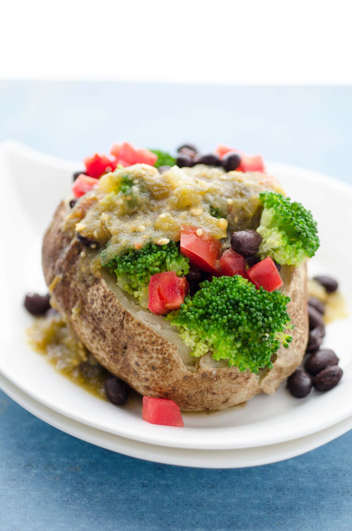 Mexican stuffed loaded baked potato on a white bowl.