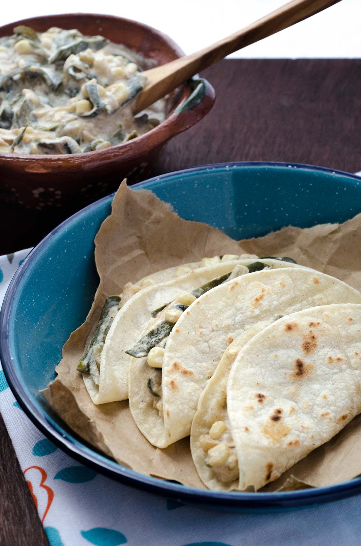 Vegan Rajas con Crema Tacos on a blue dinner plate.