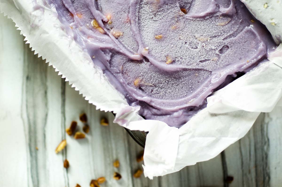 Purple sweet potato ice cream in a parchment lined loaf pan.