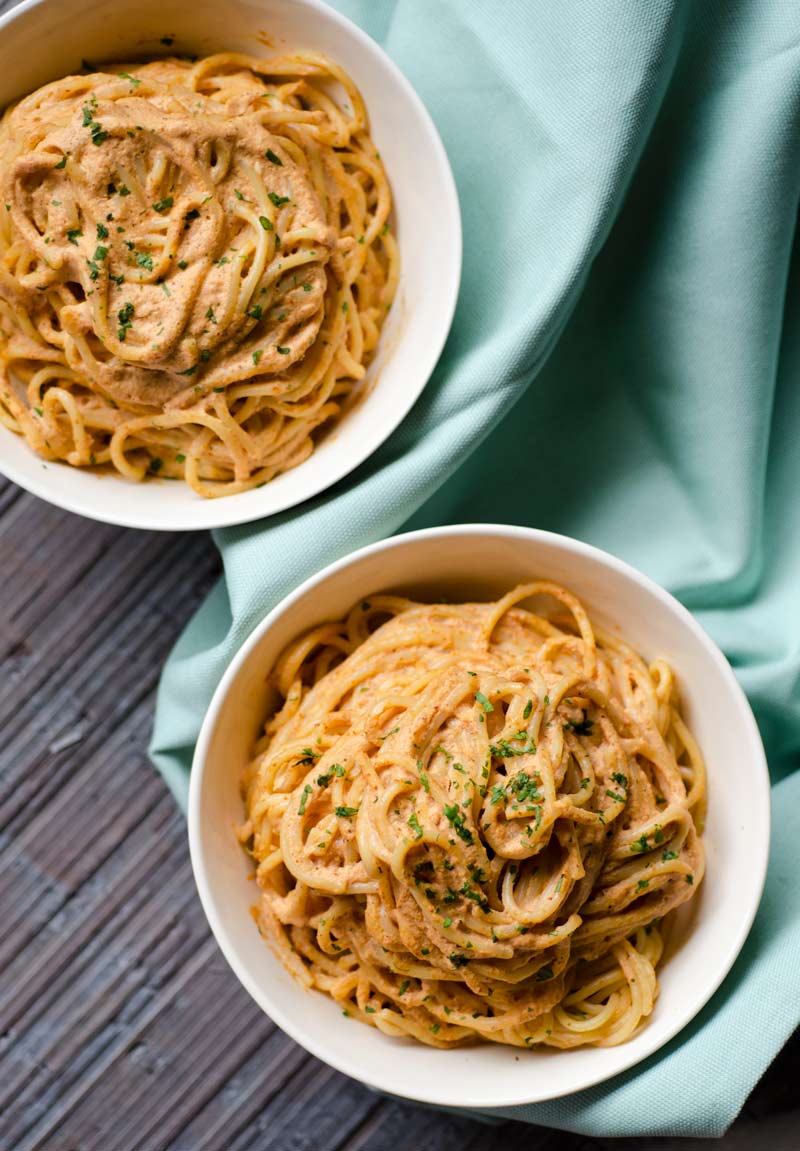 Creamy chipotle pasta in two small white bowls.