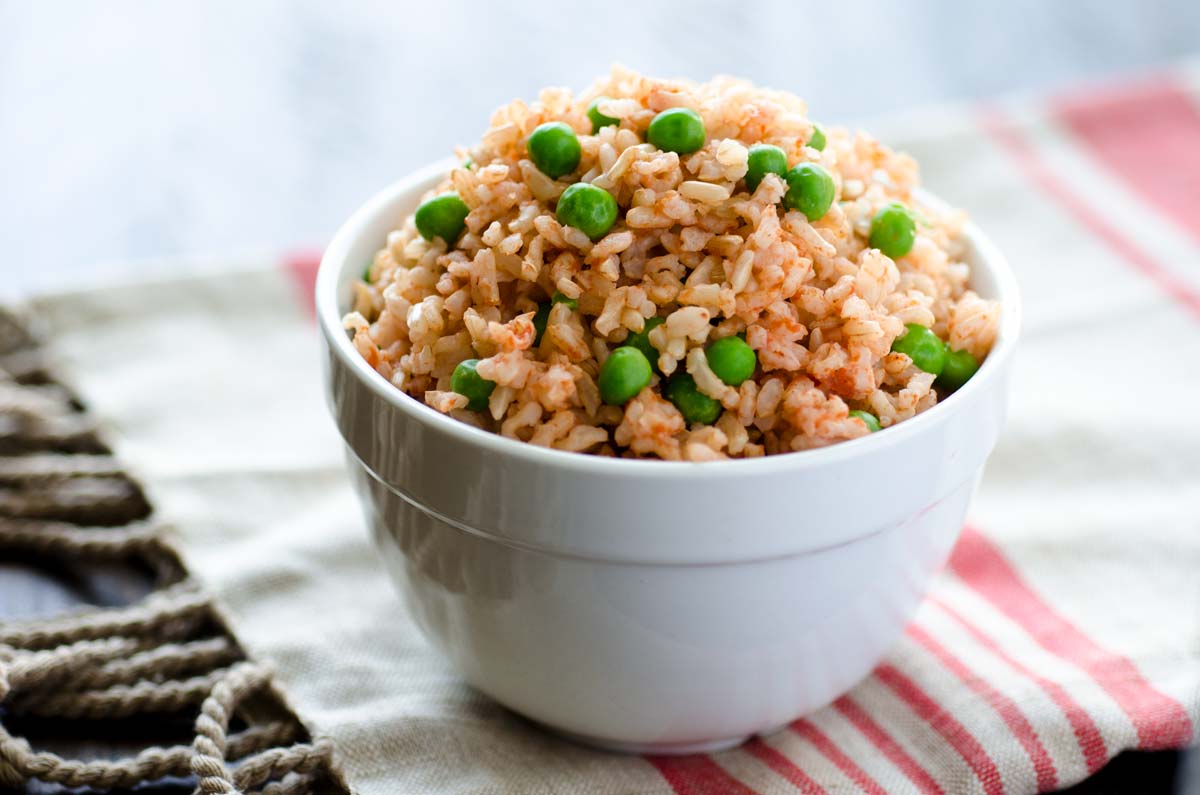 The perfect vegan Mexican brown rice, made with a very traditional recipe. It has just the right texture and balance of tomato-garlic flavor.