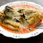 This recipe for vegan chiles rellenos is truly fantastic! They are crispy, melty, spicy and served on a garlicky tomato sauce.