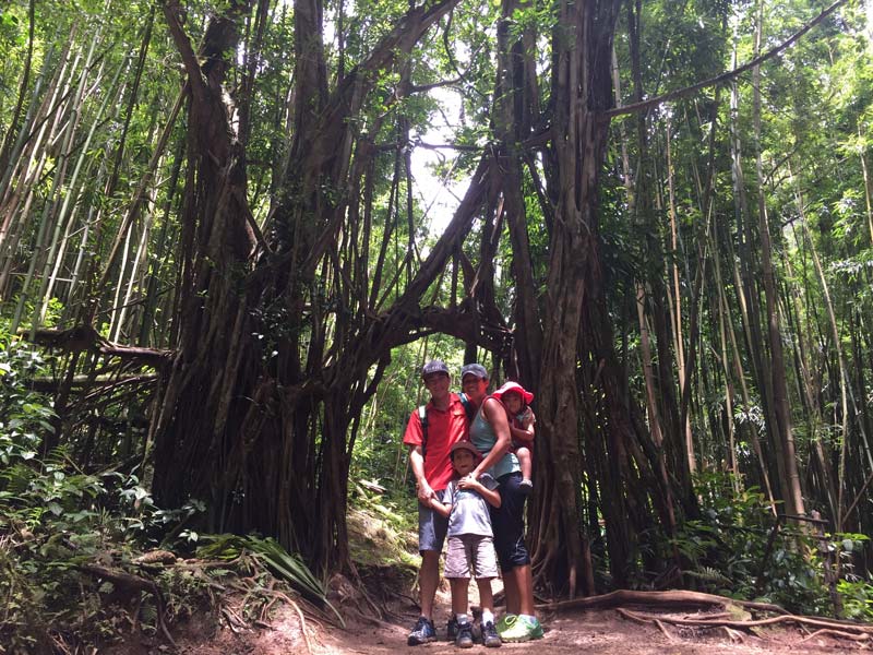 Family photo on a red dirt path in the woods.