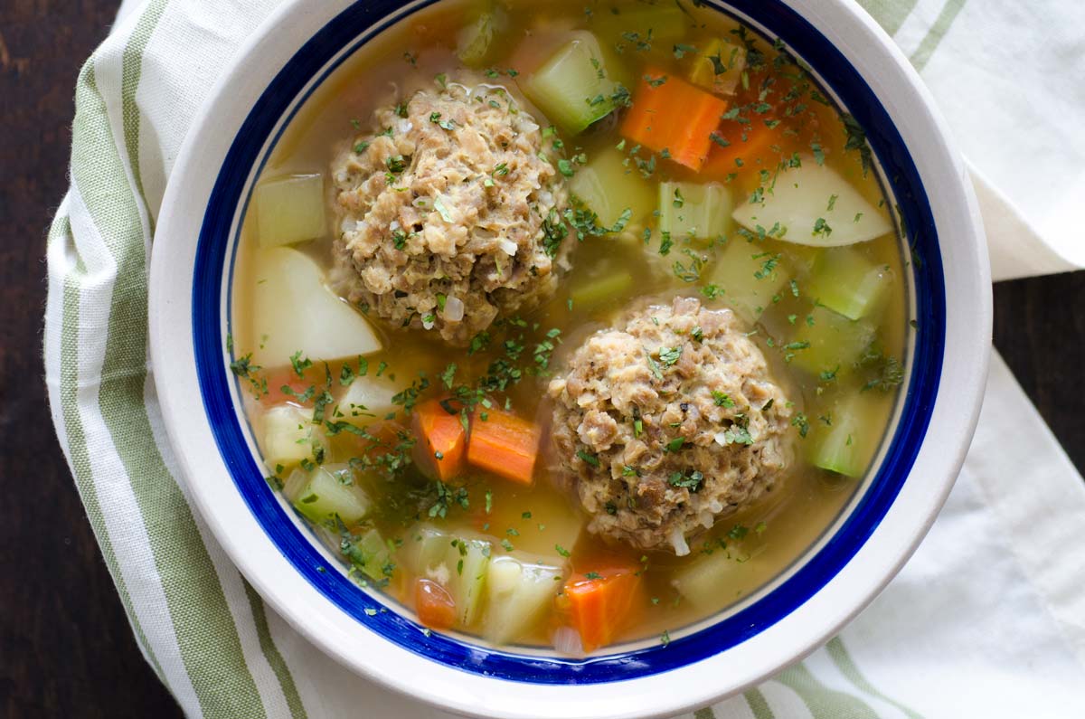 Top view of vegan Mexican meatball soup in a blue and white striped bowl.