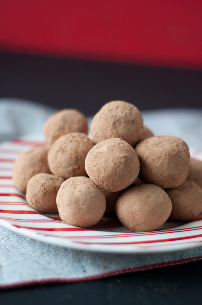 Vegan Tequila Truffles stacked on a red and white striped plate.