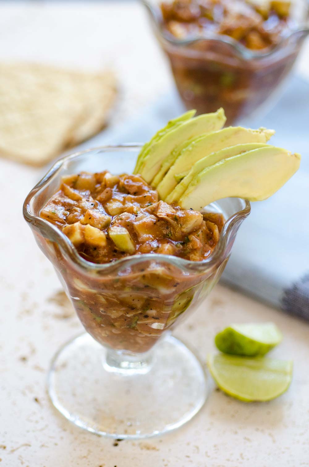 Vegan Mexican shrimp cocktail and avocado slices in a parfait cup.