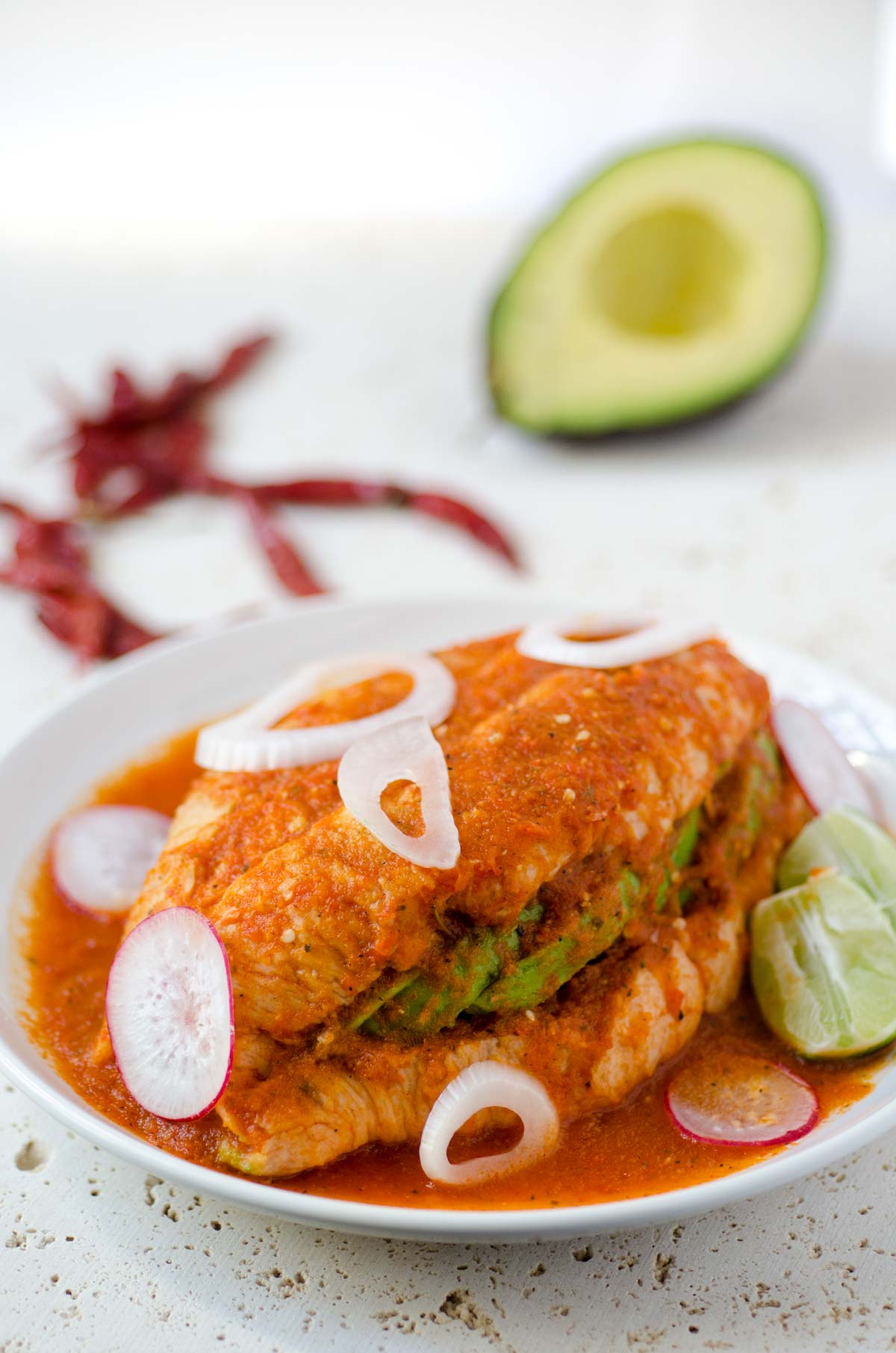 This Torta ahogada recipe is a crusty bread torta filled with refried beans and avocado, and drowned in a spicy chile de arbol salsa.