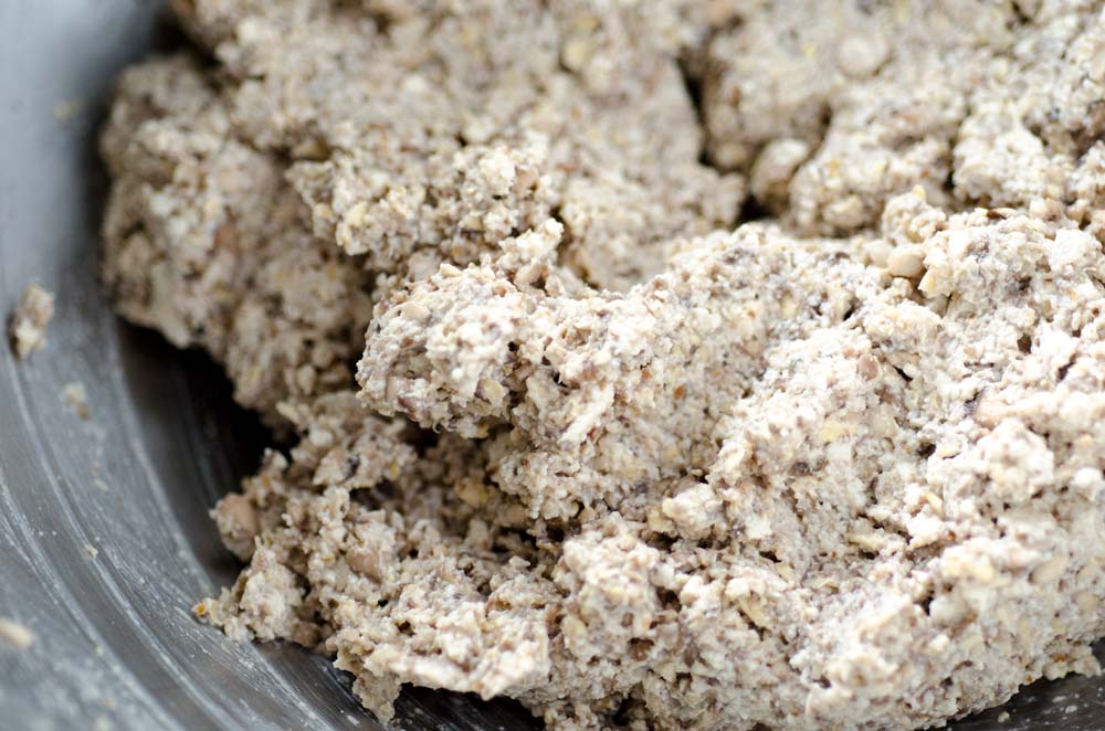 Tofu meatballs mixture in a metal mixing bowl.