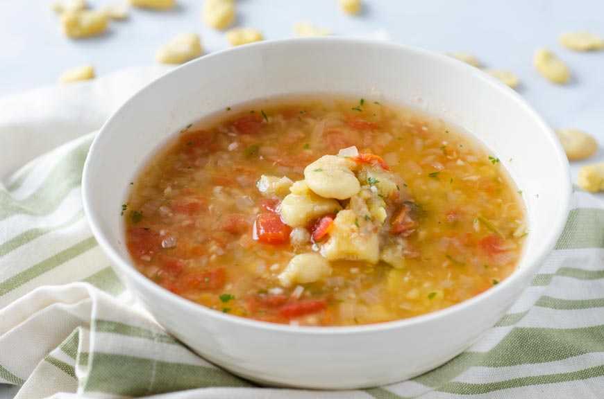 Closeup of a white bowl of Mexican fava bean soup.