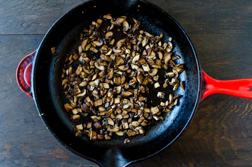 Sauted diced mushroom in a large saute pan.