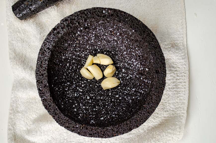 6 cloves of garlic in a molcajete 