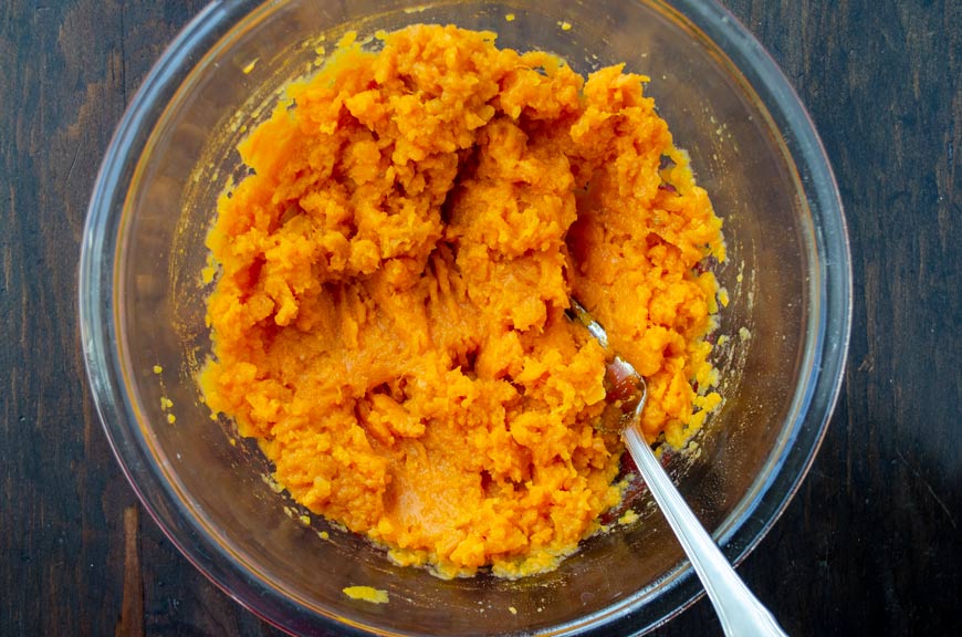 Mashed sweet potato in a glass bowl