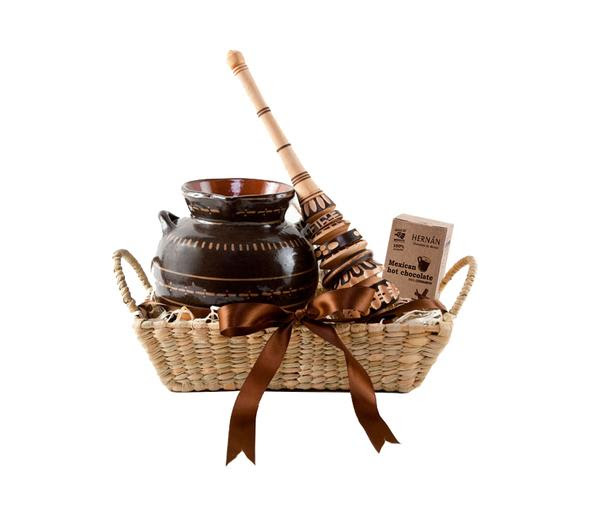 Wicker basket with clay pot and mexican hot chocolate mixer inside.