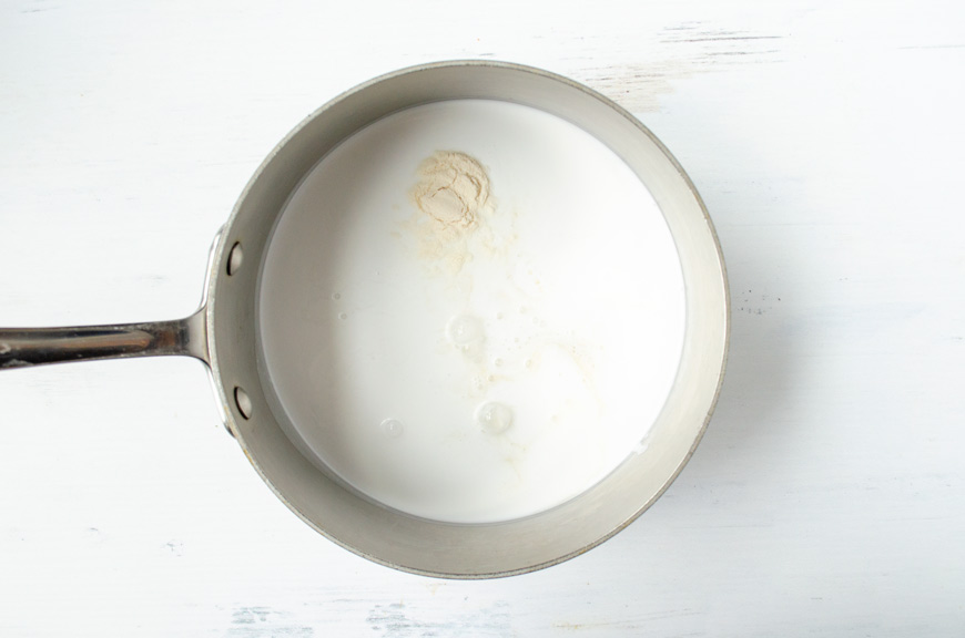 Coconut milk and agar agar in a stainless steel saucepot