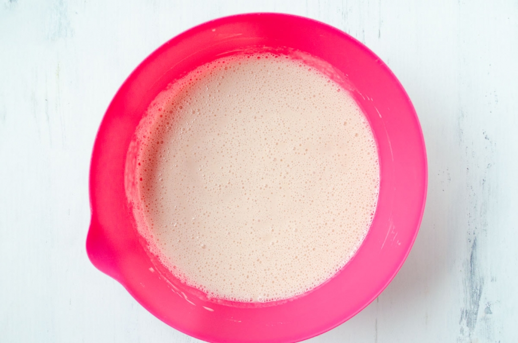 Blended strawberry mixture in a pink bowl.