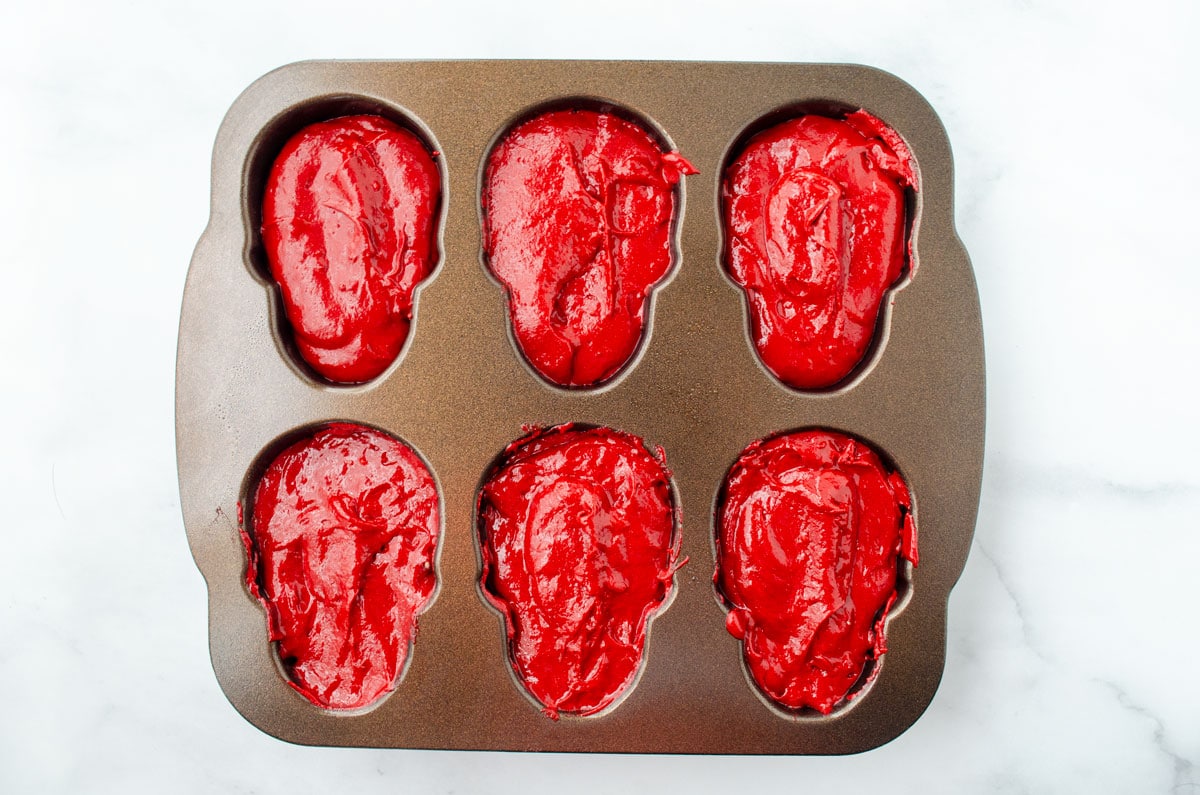 red cake batter in skull cake pan