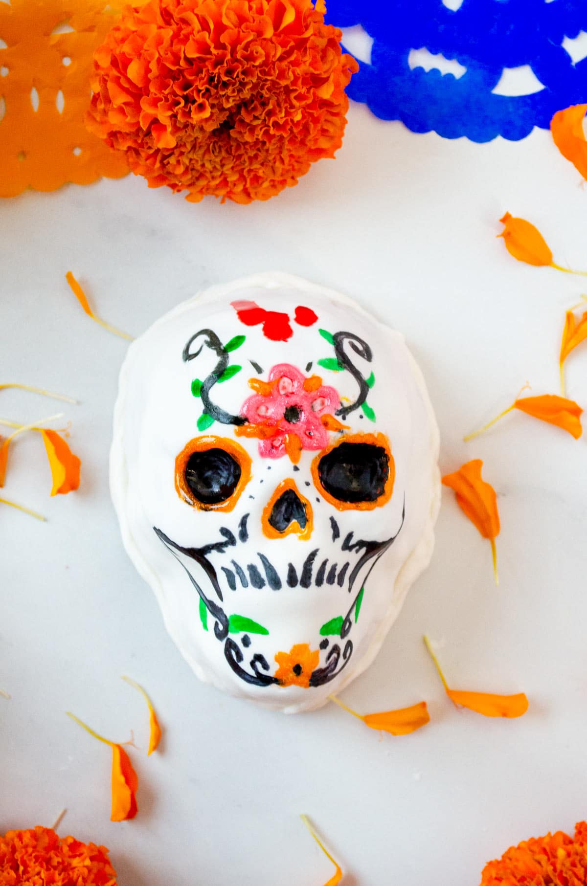 cake shaped like a skull decorated with colorful flowers