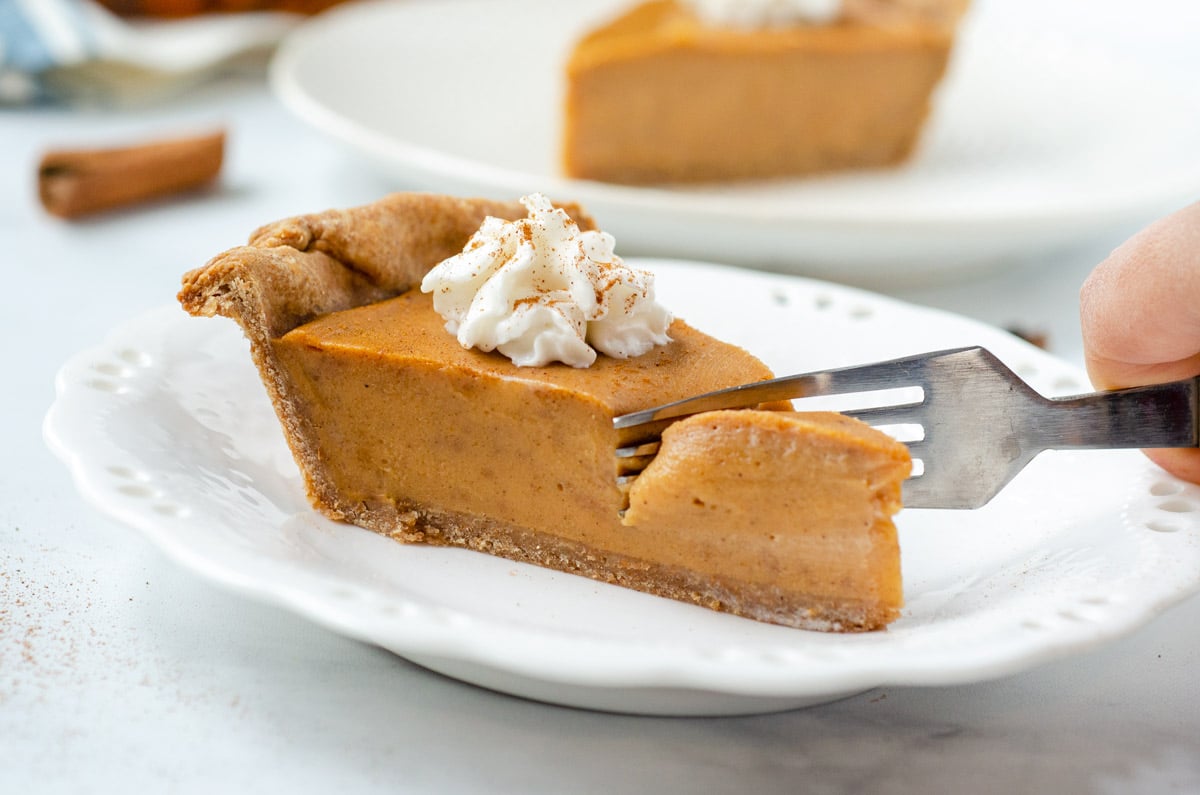 a fork cutting into sweet potato pie