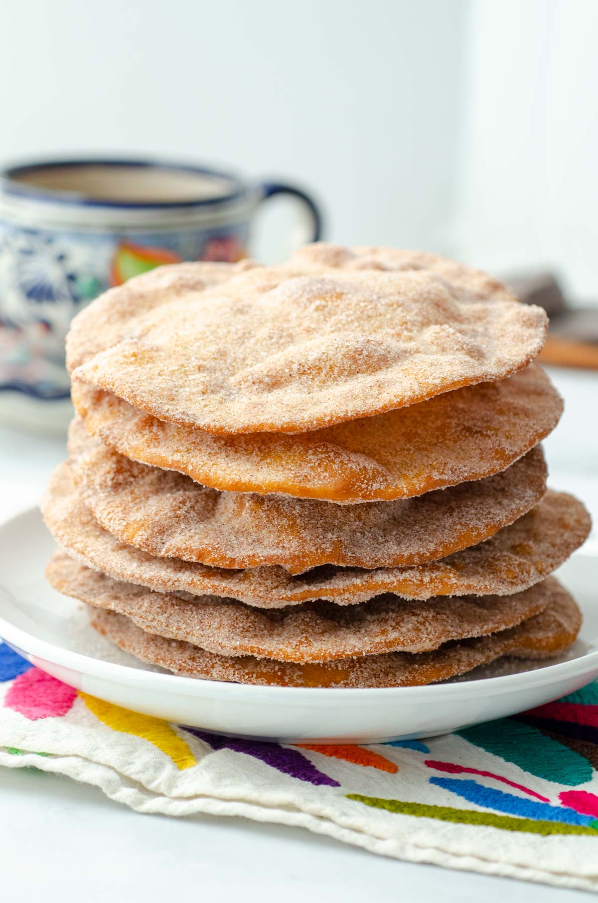 stack of Mexican buñuelos on an otomi embroidered napkin