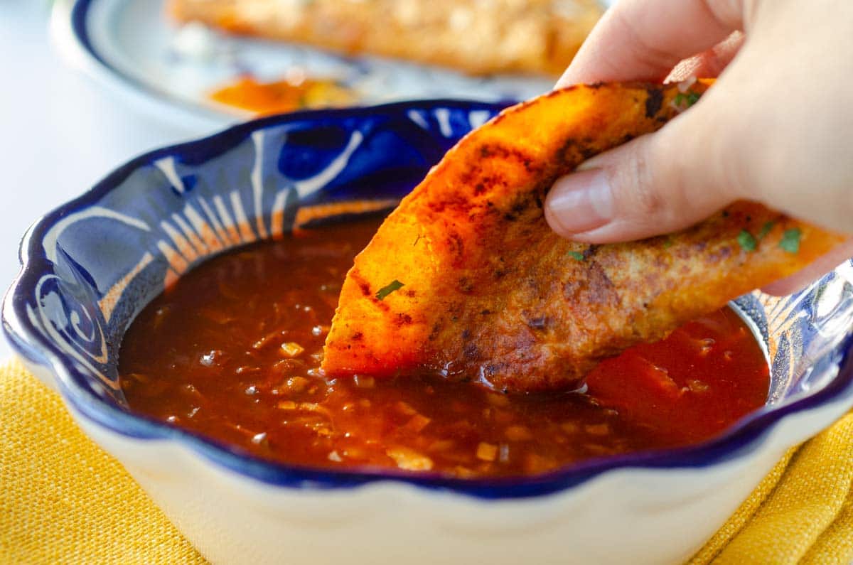 a closeup of the taco being dipped in the broth