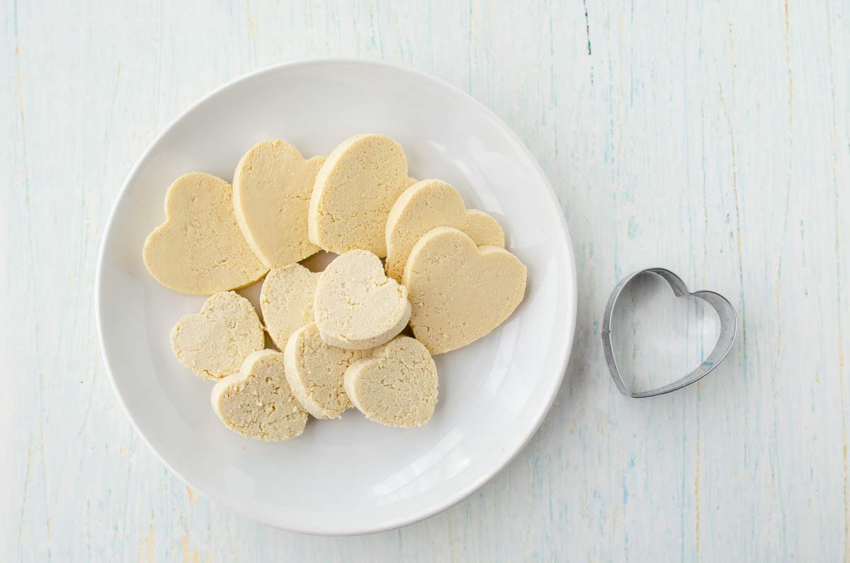 tofu cut into hear shaped on a white plate