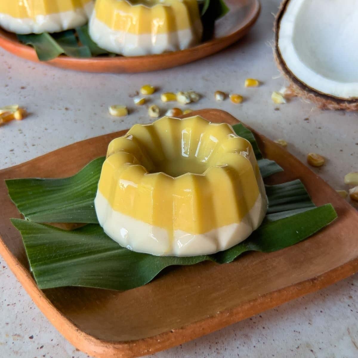 passion fruit and coconut nicuatole on a banana leaf and clay plate