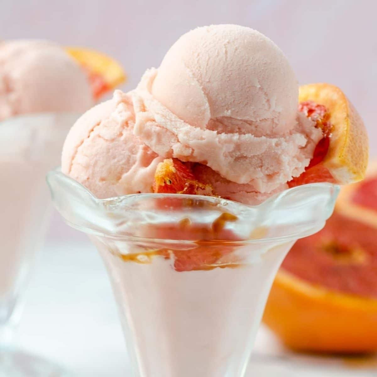 grapefruit ice cream in a cup with broiled grapefruit