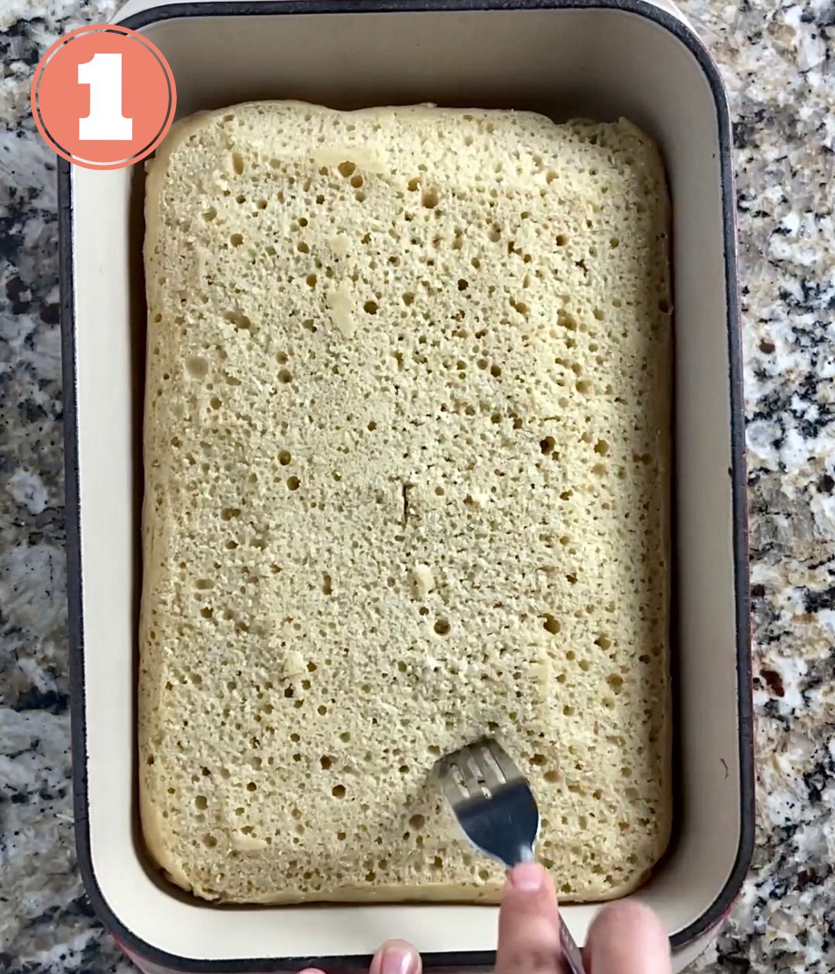 fork poking holes in a cake