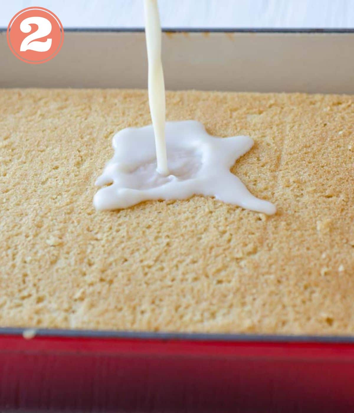 milk being poured on cake