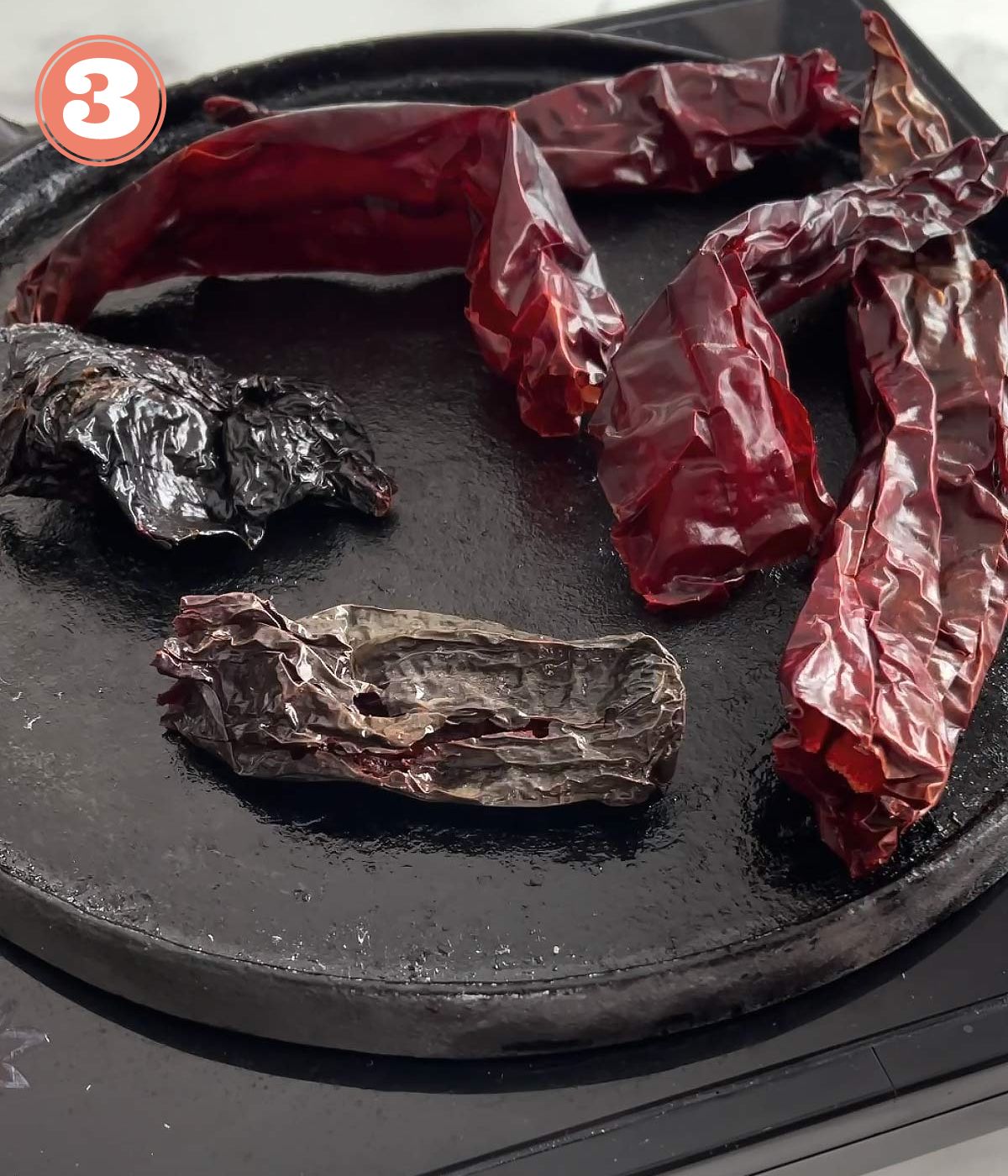 dried chiles on a comal