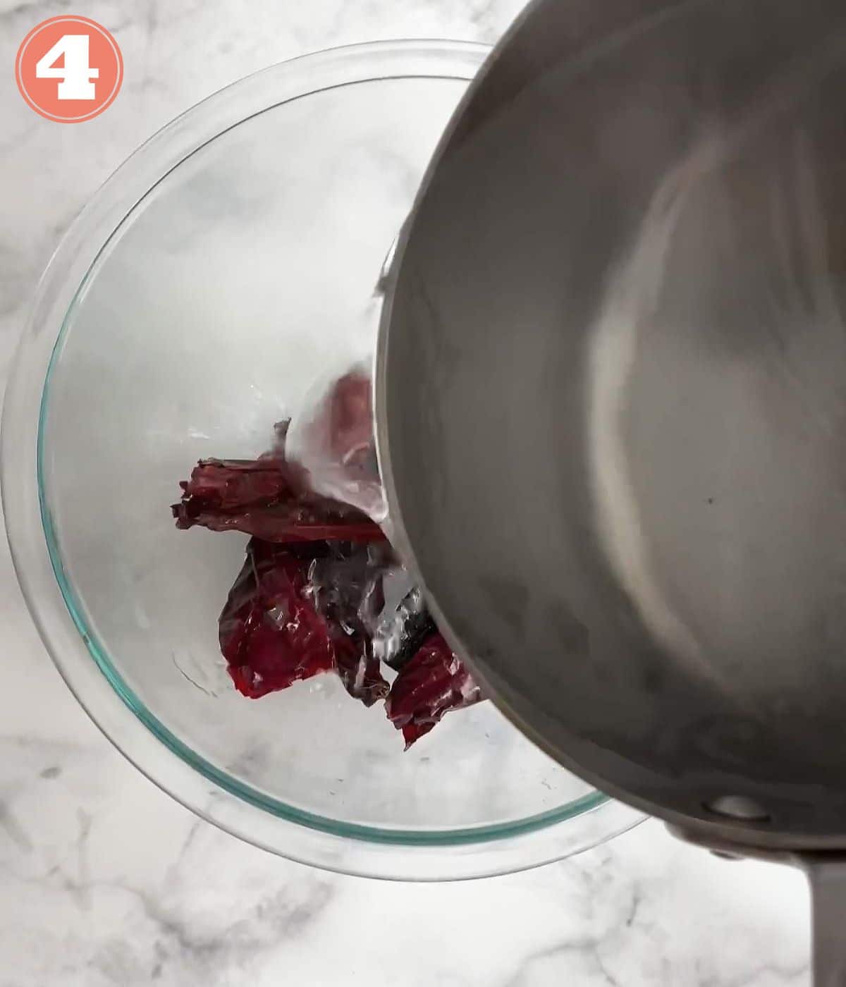 hot water pouring over a bowl of chiles