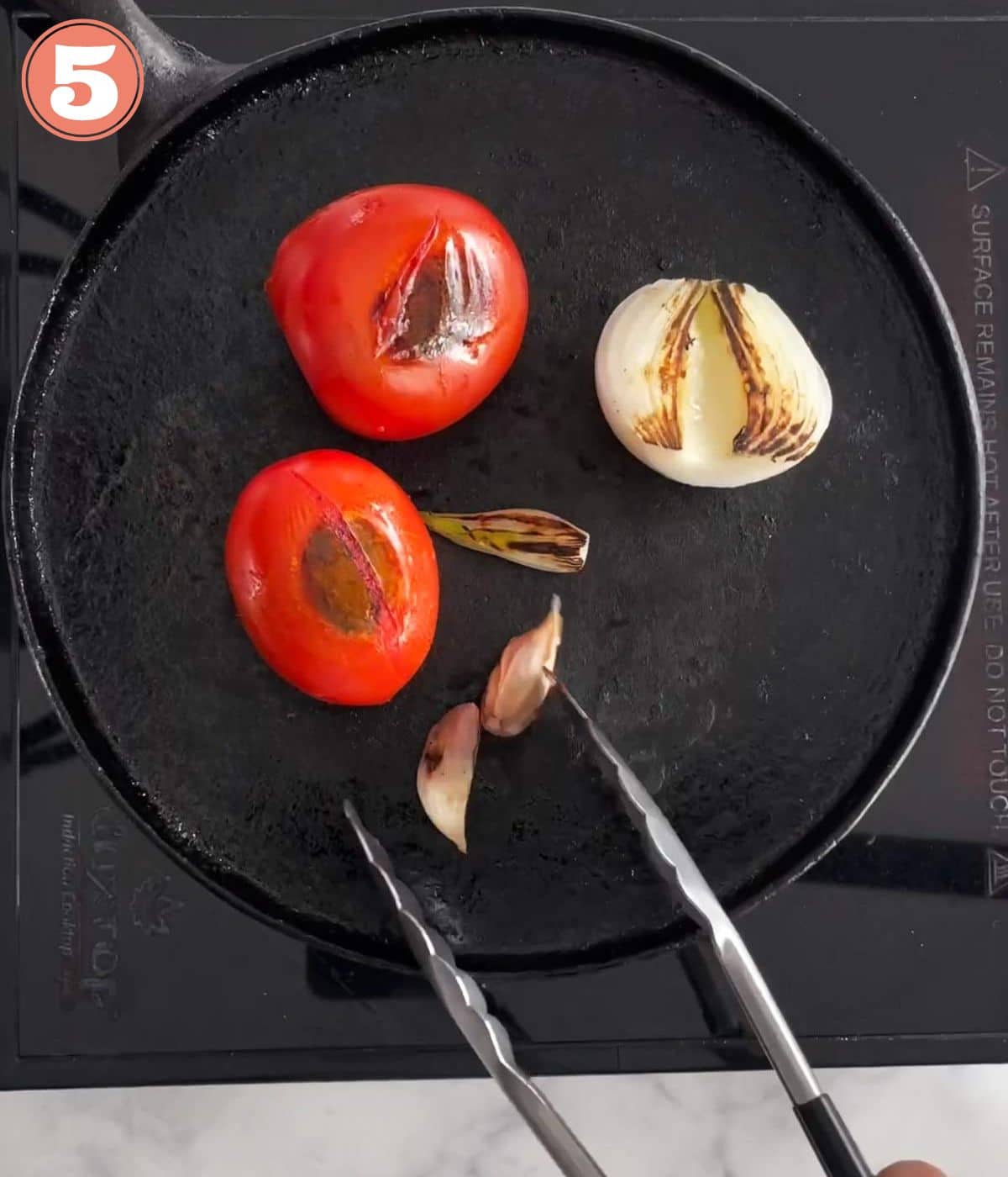 tomato, onion, and garlic on a comal