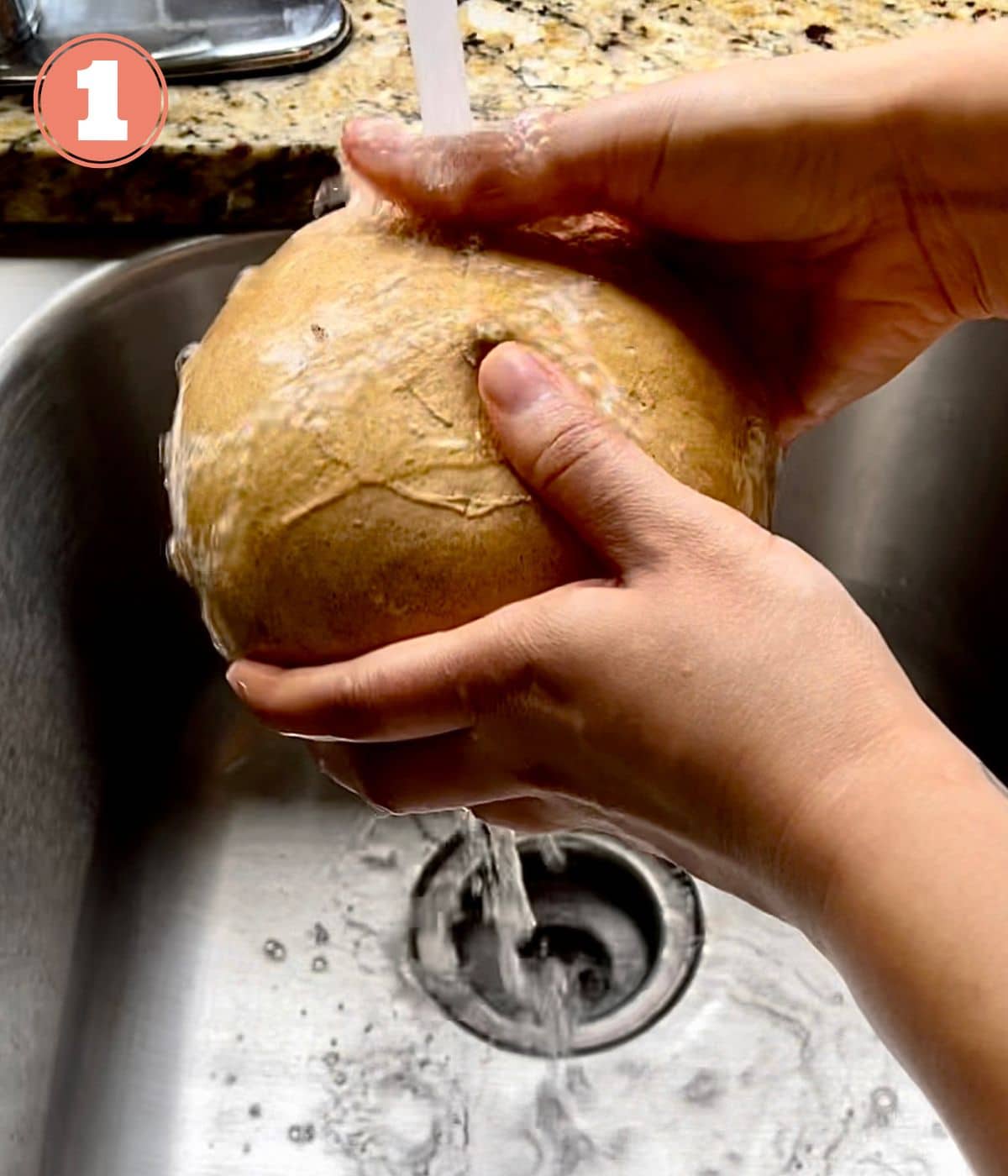 Jicama being rinsed under running water in a sink.