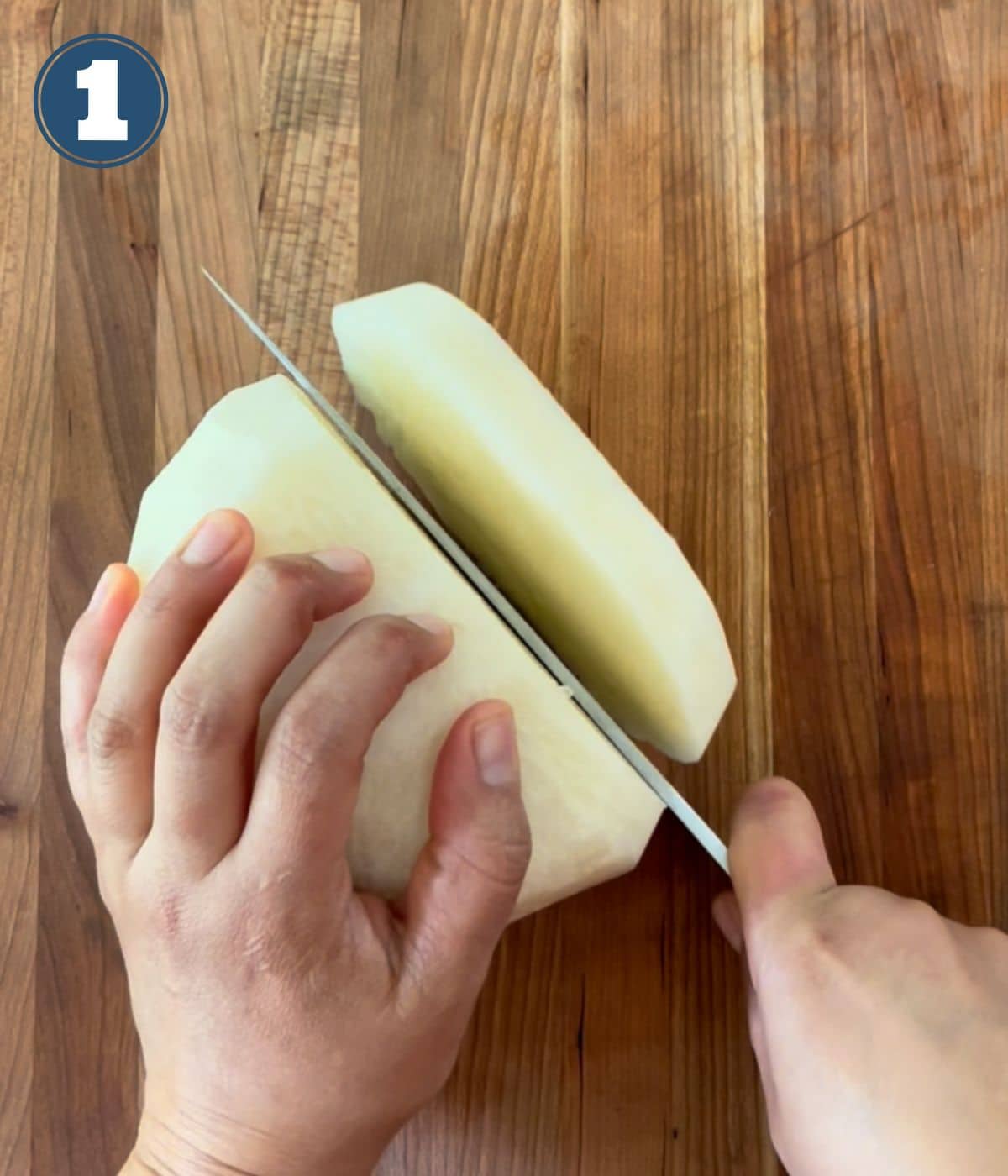 A knife cutting into a whole jicama.