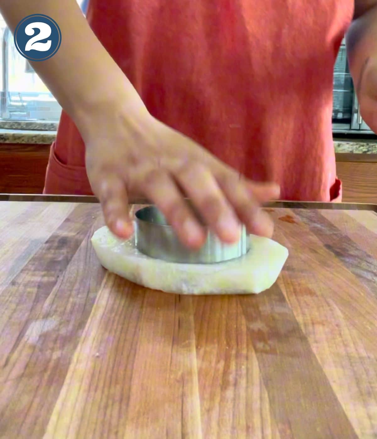 A cookie cutter cutting into jicama slice.