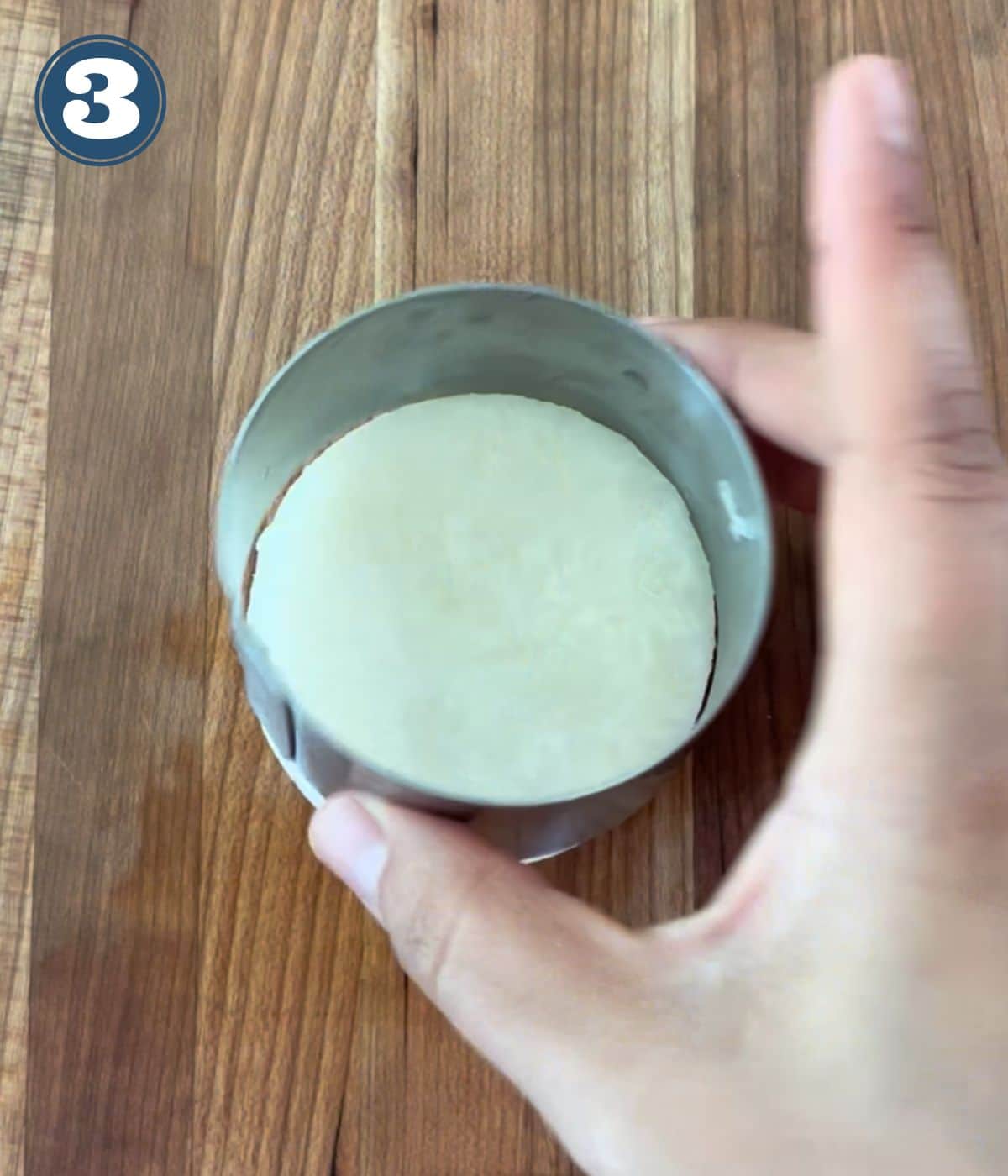 Cutting a circle from the jicama with a cookie cutter.