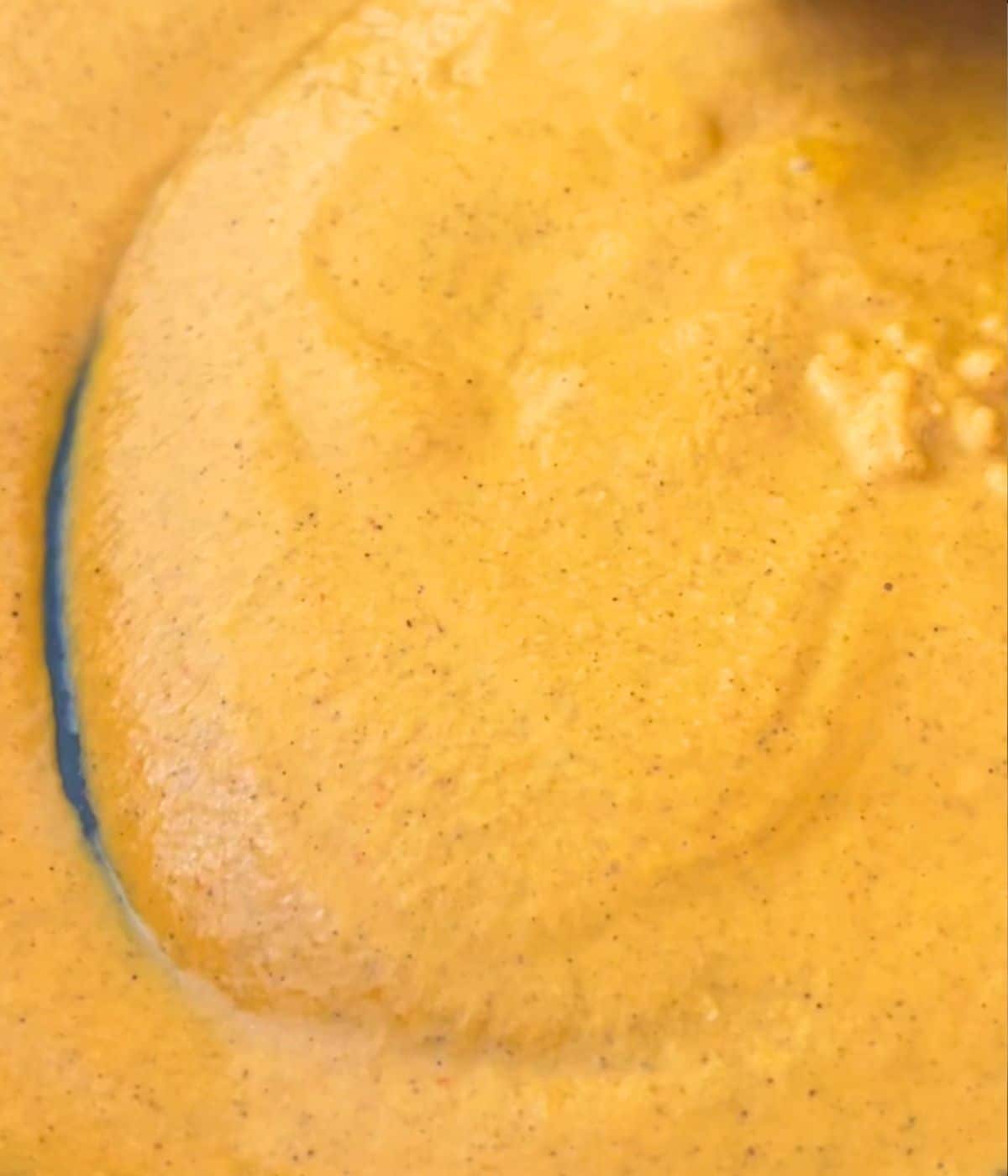 Sauce simmering in a blue skillet.