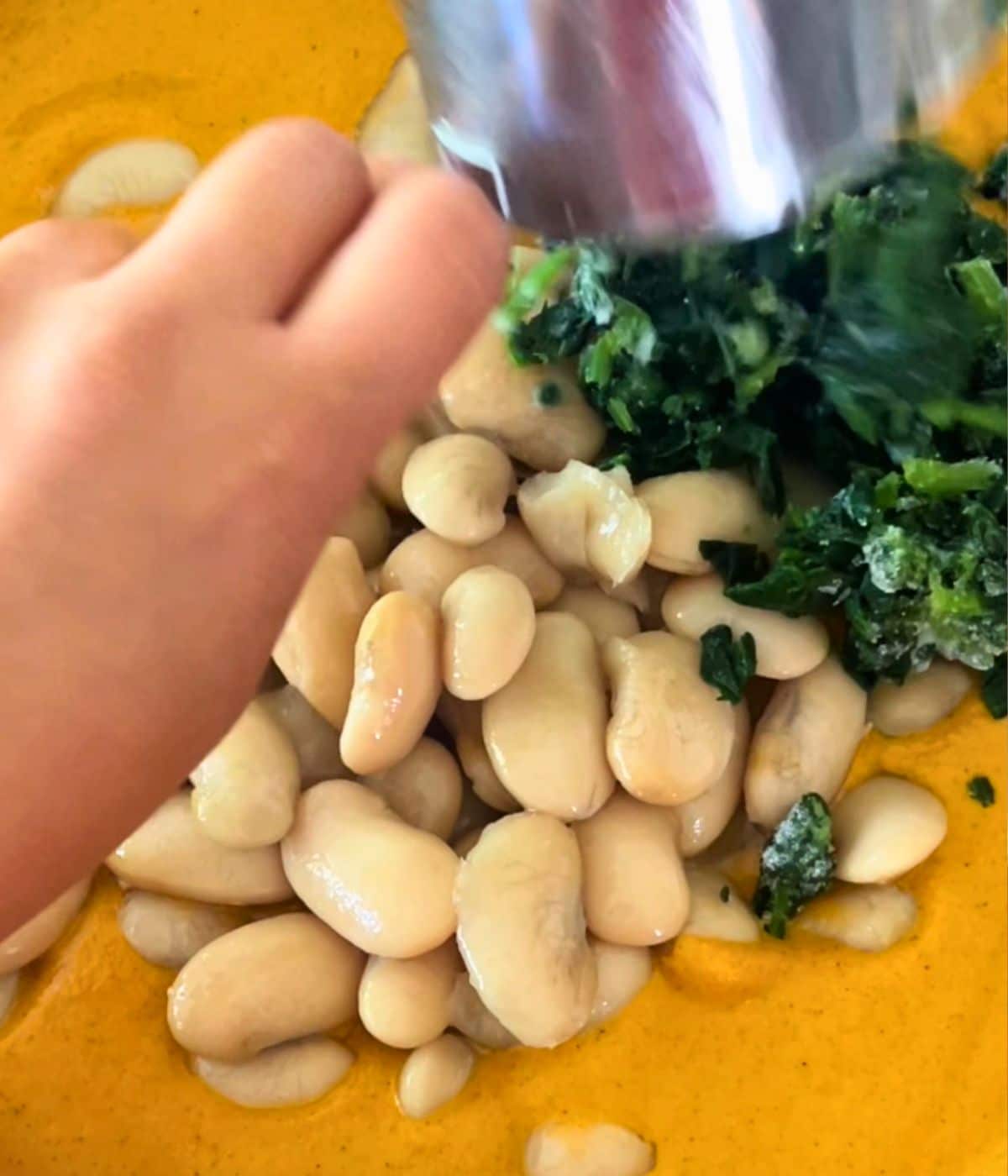 White beans and spinach added to the skillet with the chipotle sauce.