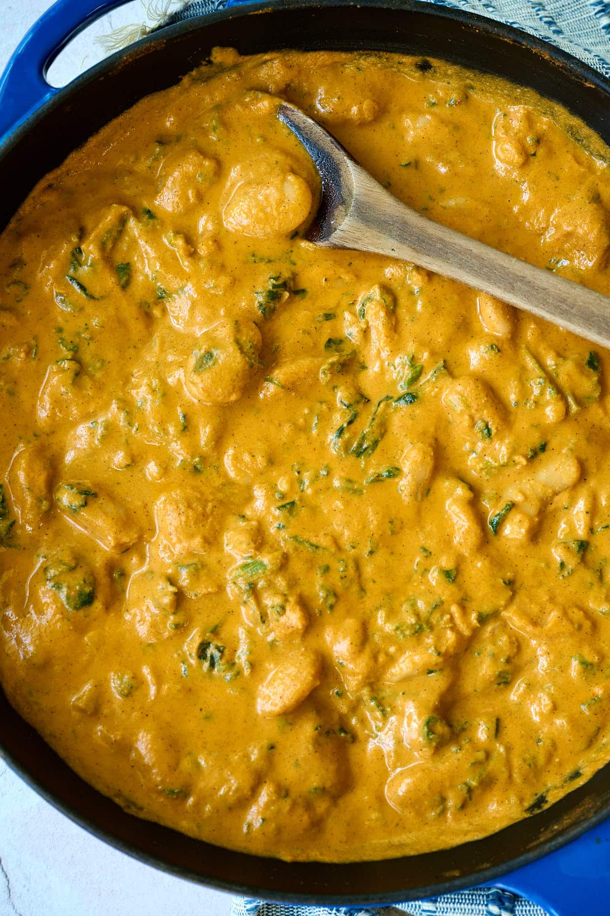 beans in a creamy chipotle sauce in a blue skillet