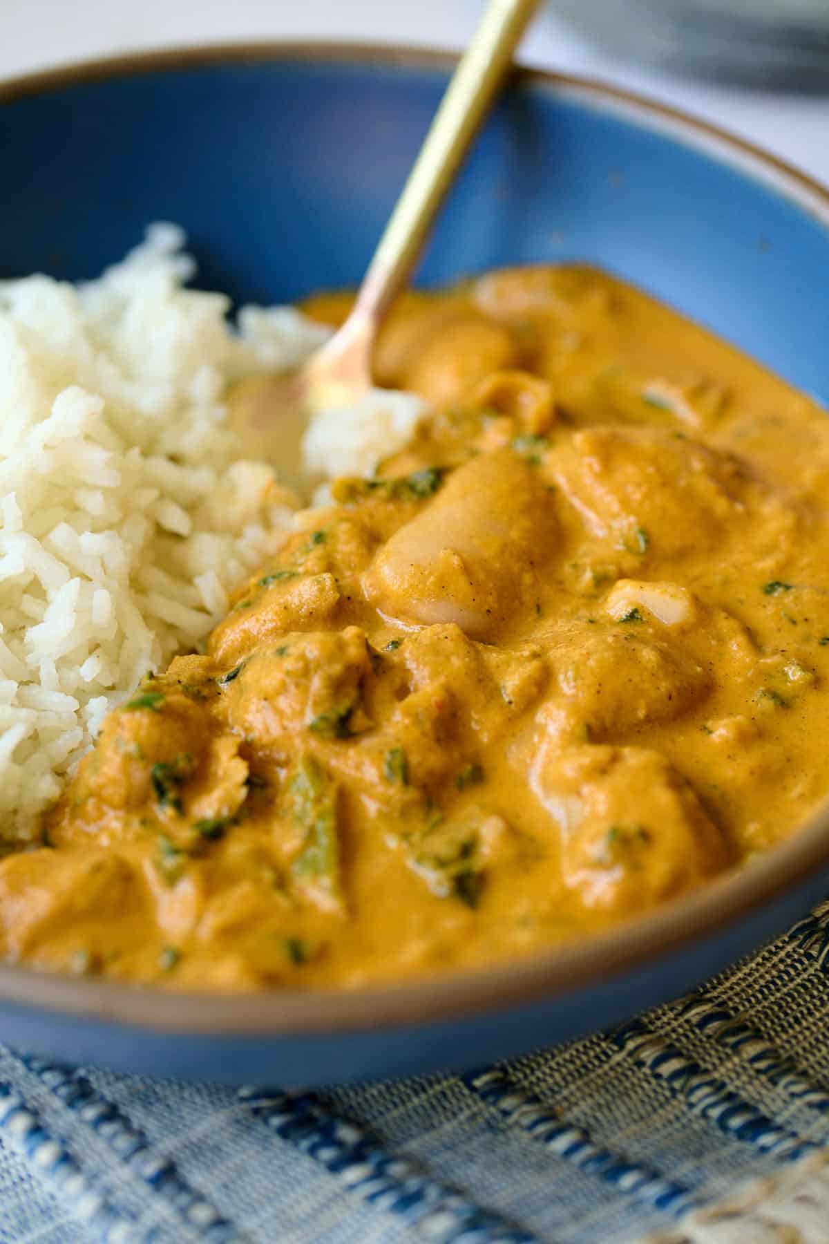 a blue plate with rice and creamy chipotle beans