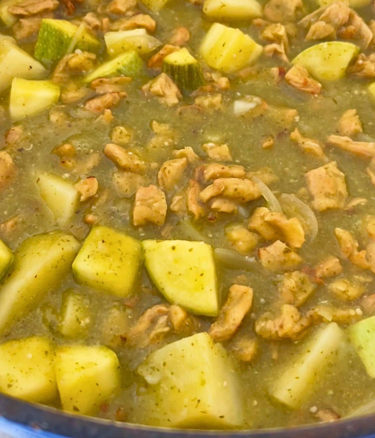 Chile verde soy curl stew simmering in a blue pot.